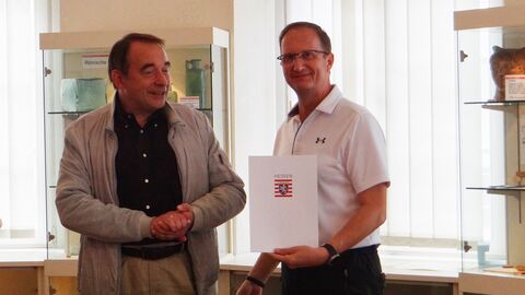 Hessens Finanzminister Professor Dr. R. Alexander Lorz übergibt den Förderbescheid an den Vorsitzenden des Heimatvereins Kostheim, Michael Auth.